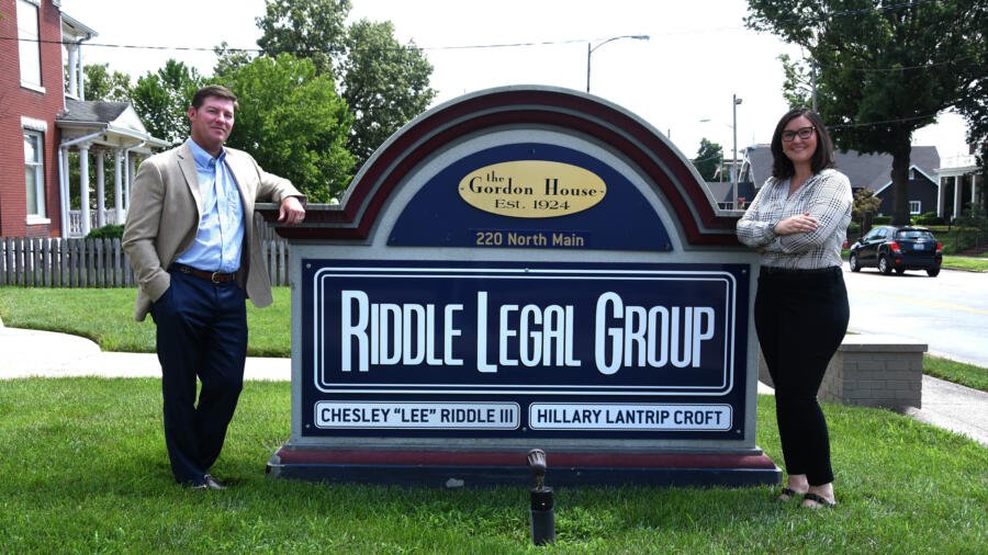Lee and Hillary in front of the Riddle Legal Sign